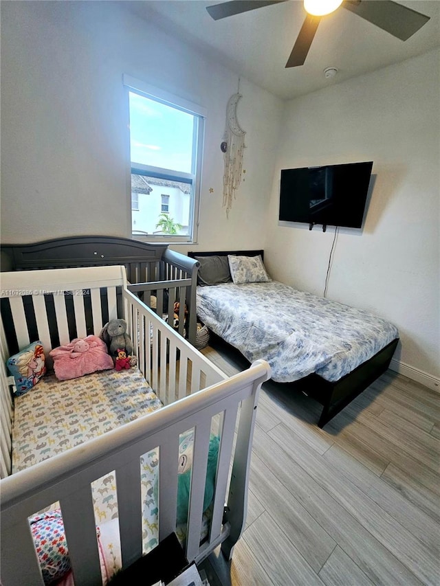 bedroom featuring ceiling fan and light hardwood / wood-style flooring