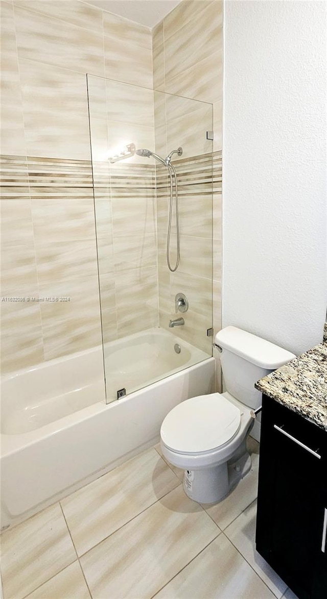 full bathroom with tile patterned flooring, vanity, toilet, and tiled shower / bath combo