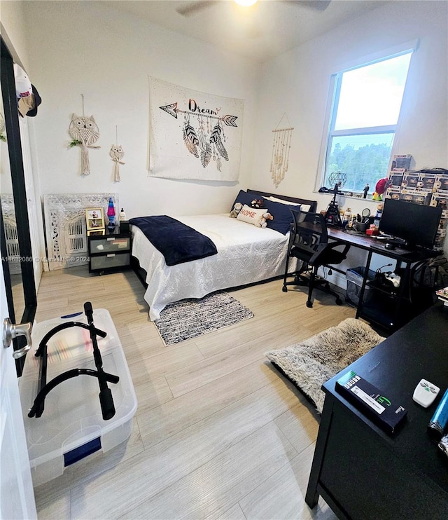 bedroom featuring hardwood / wood-style floors and ceiling fan