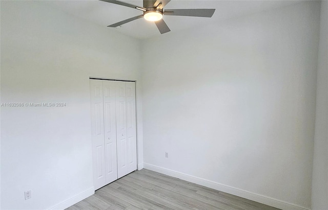 unfurnished bedroom featuring a closet, ceiling fan, and light hardwood / wood-style flooring