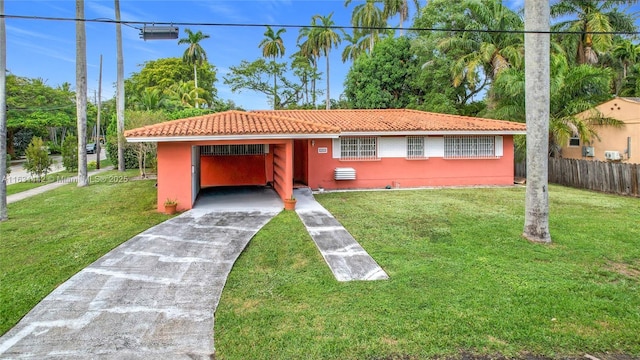 view of front of house featuring a front lawn and a carport