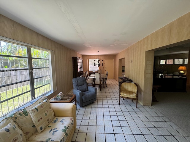 living room with light tile patterned floors and a chandelier