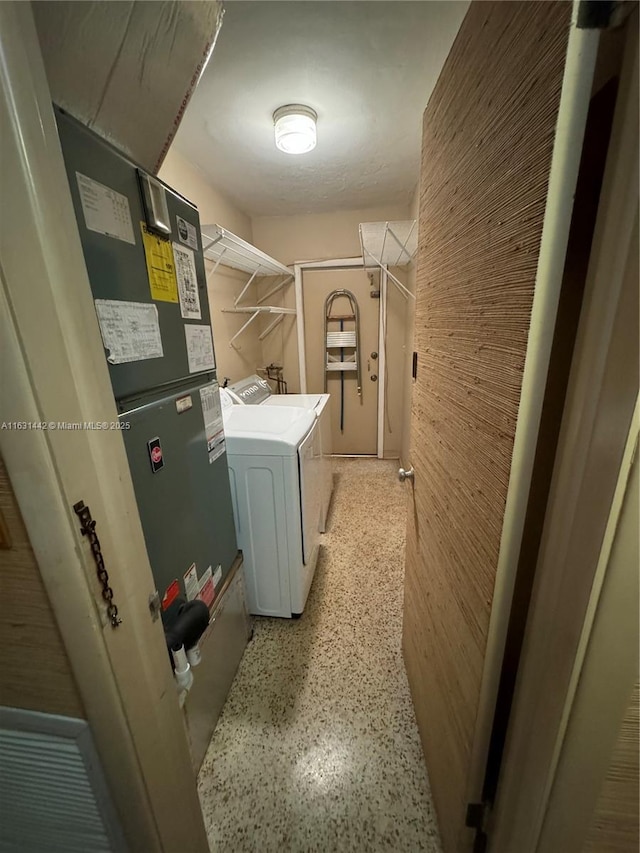 clothes washing area featuring washer and dryer