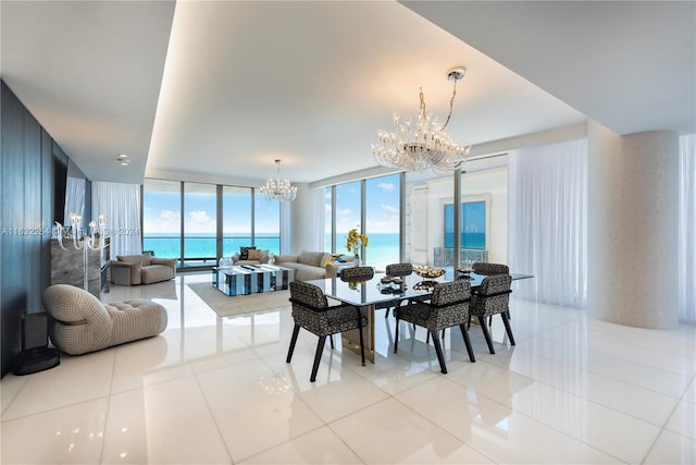 tiled dining space with a water view, expansive windows, and a chandelier