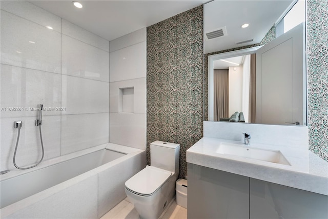 bathroom with tile walls, vanity, and toilet