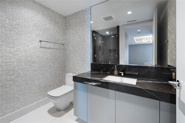 bathroom with tile patterned flooring, vanity, a shower, and toilet