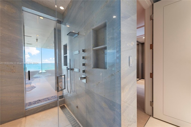 hallway with a water view and tile patterned floors