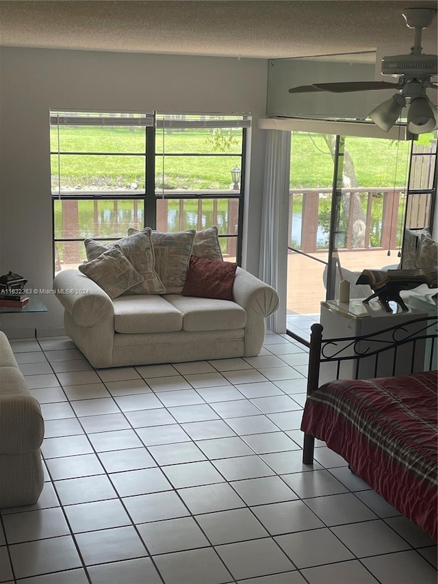 tiled bedroom featuring access to outside, multiple windows, and ceiling fan