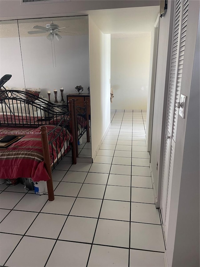 bedroom with light tile patterned flooring and ceiling fan