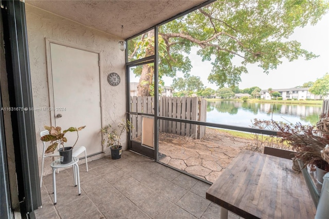 unfurnished sunroom with a healthy amount of sunlight and a water view