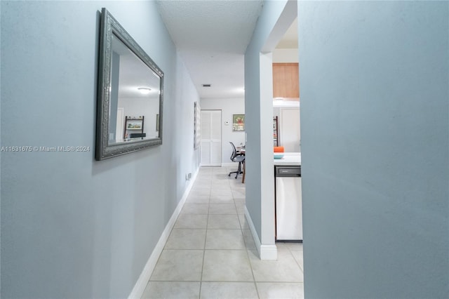 hallway with light tile patterned floors