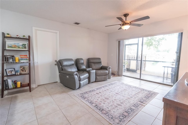 tiled living room with ceiling fan