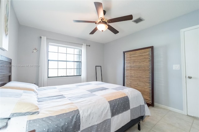 bedroom with ceiling fan and light tile patterned floors