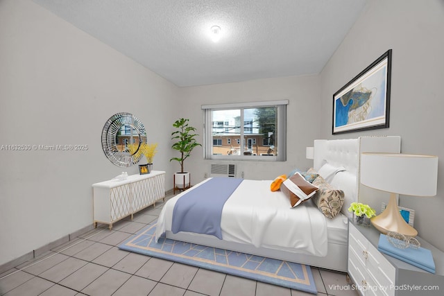 bedroom featuring visible vents, a textured ceiling, and light tile patterned flooring