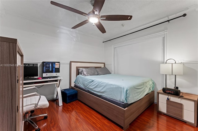 bedroom with dark hardwood / wood-style flooring, a textured ceiling, and ceiling fan