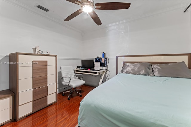 bedroom featuring crown molding, dark hardwood / wood-style floors, and ceiling fan