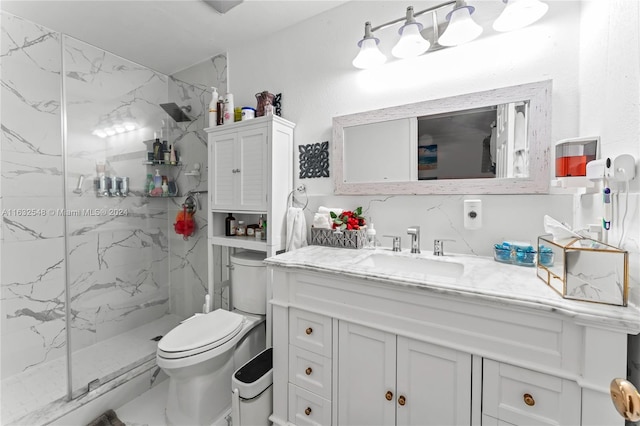 bathroom with tiled shower, vanity, and toilet