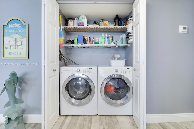 washroom featuring washing machine and dryer and light wood-type flooring