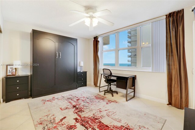 bedroom with ceiling fan and light tile patterned floors