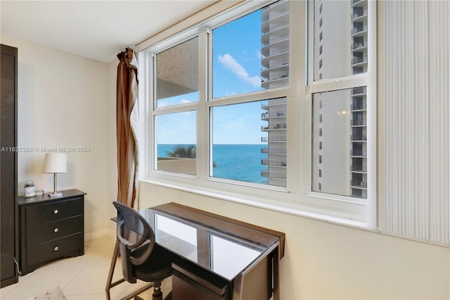 home office with a water view and light tile patterned floors