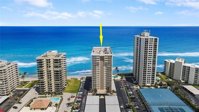 birds eye view of property featuring a water view and a beach view