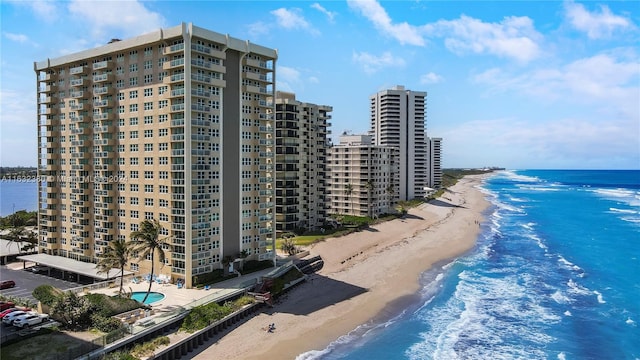 birds eye view of property with a water view and a view of the beach