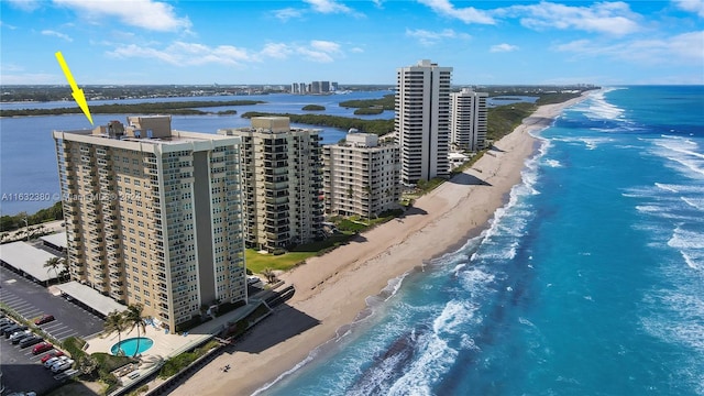 bird's eye view with a water view and a beach view