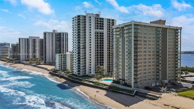 drone / aerial view featuring a beach view and a water view