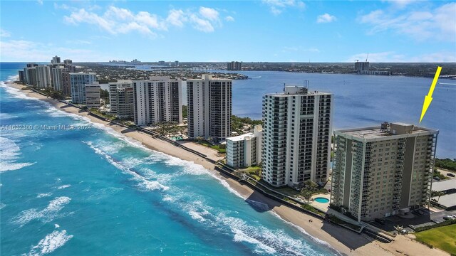 birds eye view of property featuring a view of the beach and a water view