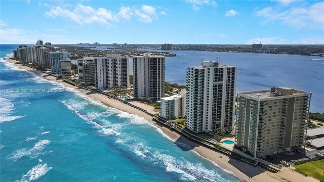 aerial view with a water view and a beach view