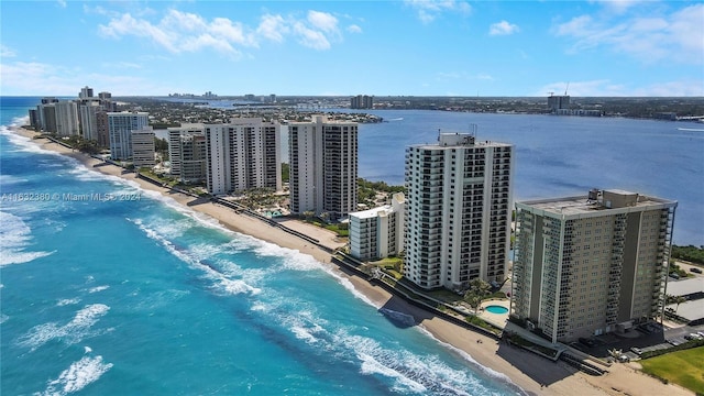 birds eye view of property featuring a beach view and a water view