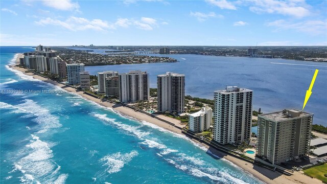 aerial view with a water view and a view of the beach