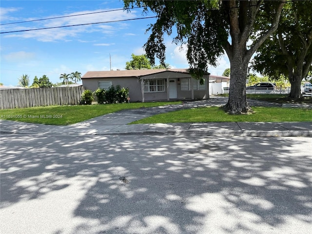 ranch-style home featuring a front lawn