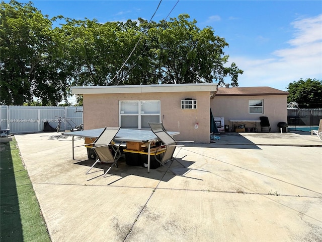 back of house with a patio