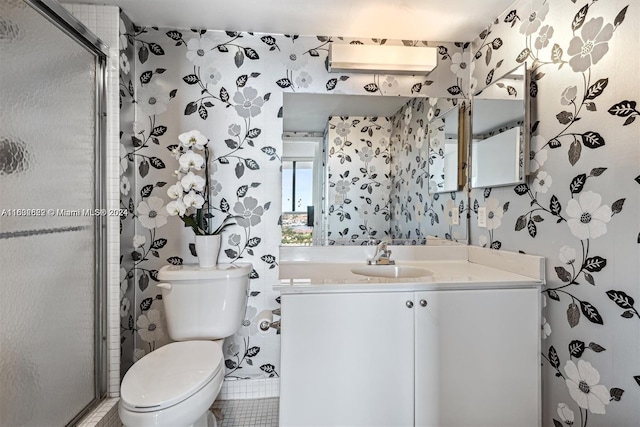 bathroom featuring toilet, a shower with door, and vanity