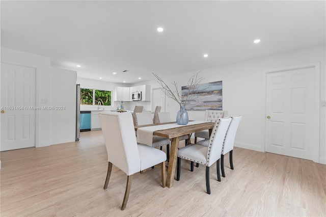 dining room featuring light wood-type flooring and sink