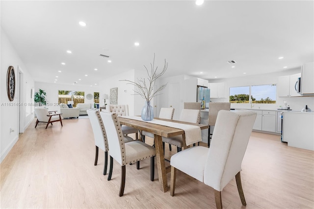 dining space with a wealth of natural light and light hardwood / wood-style floors