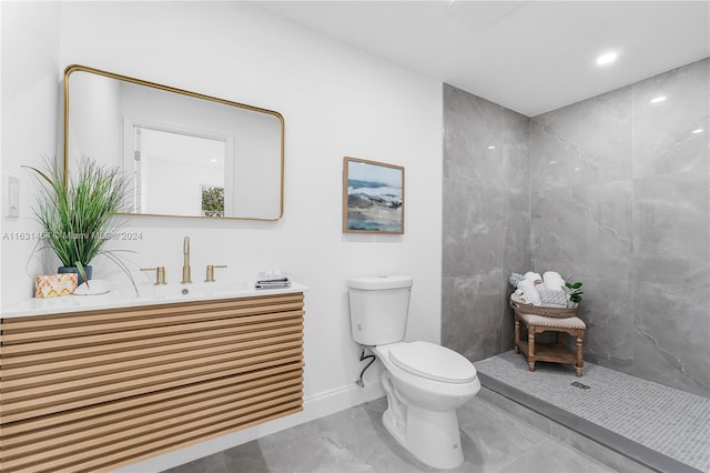 bathroom with walk in shower, toilet, vanity, and tile patterned flooring