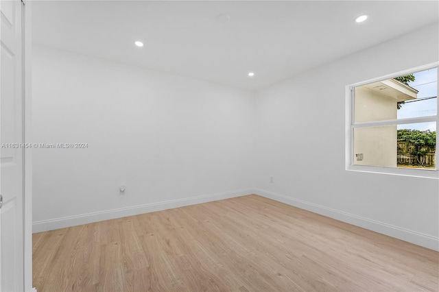 spare room with light hardwood / wood-style flooring