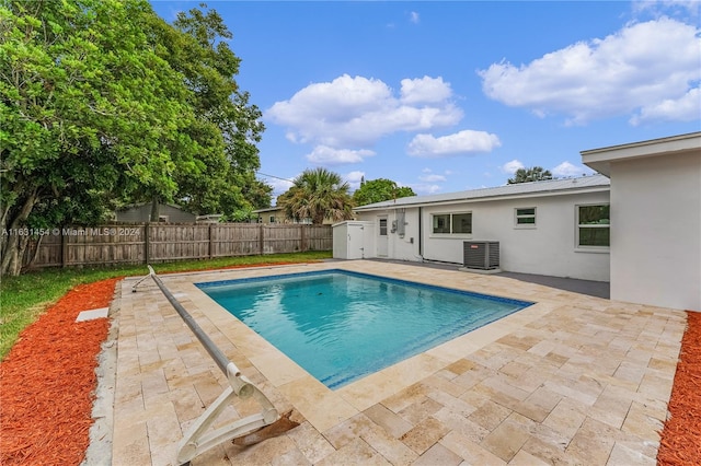 view of pool featuring central air condition unit and a patio