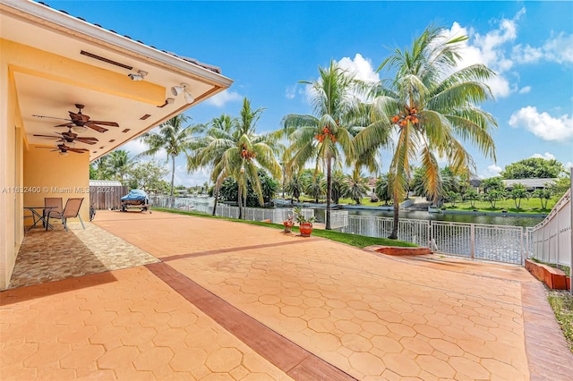 exterior space with a water view and ceiling fan