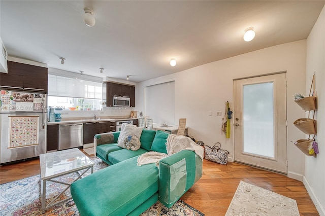 living room featuring baseboards and light wood finished floors