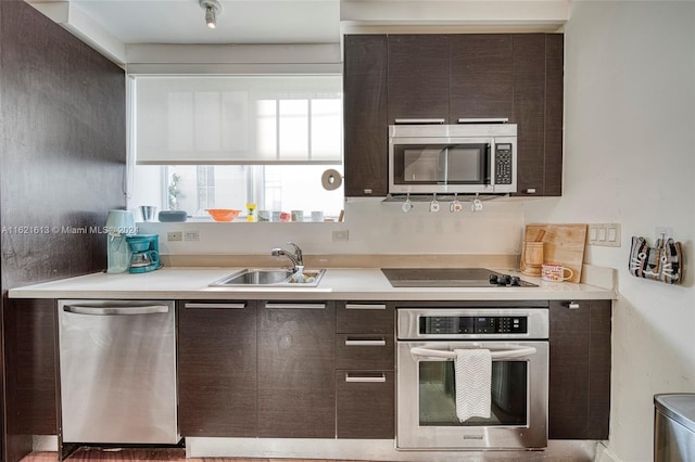 kitchen with sink, stainless steel appliances, and dark brown cabinetry