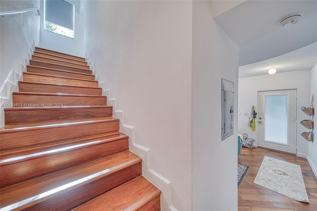 stairs featuring hardwood / wood-style floors