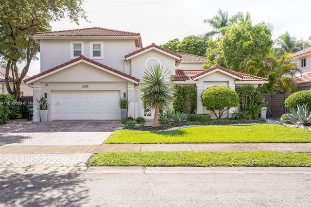 mediterranean / spanish-style home with a garage