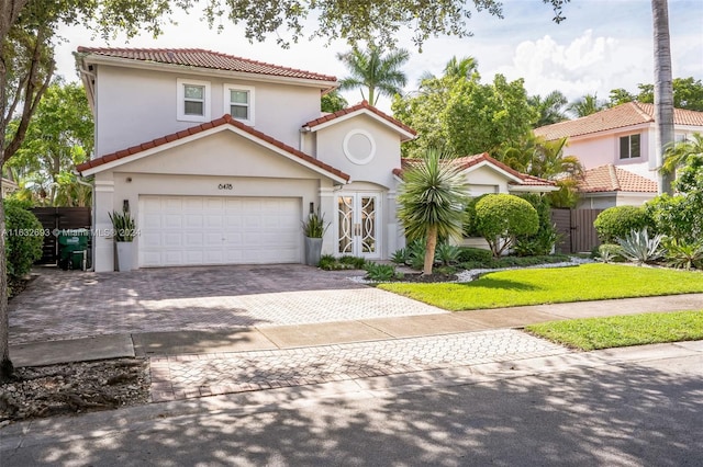 mediterranean / spanish-style house with a garage