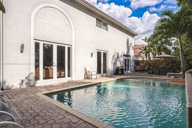 view of pool featuring a patio and a grill