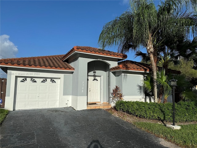 mediterranean / spanish-style house featuring a garage