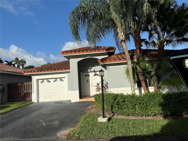 mediterranean / spanish home featuring a garage