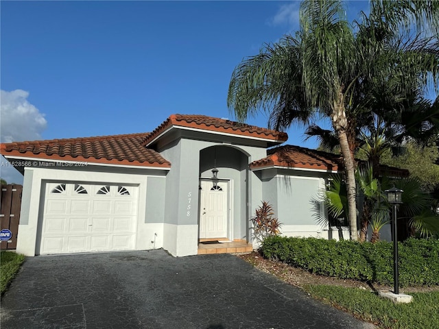 mediterranean / spanish house featuring a garage